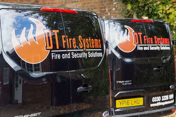 Two DT Fire Systems company vehicles parked